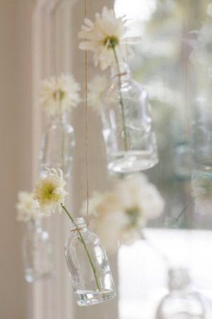 Different ideas for vases - bottles hanging by string with flowers.jpg